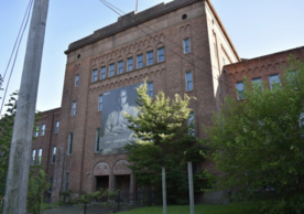 Photograph of the Goffe Street armory facade, a 1920s red brick building